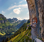Swiss Alps and a restaurant under a cliff on mountain Ebenalp in Switzerland