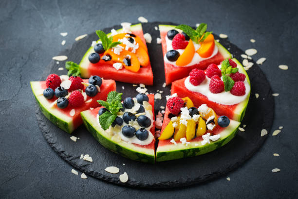 Watermelon pizza with berries, fruits, yogurt, feta cheese stock photo