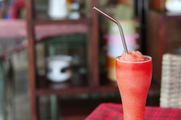 Watermelon smoothie in crystal glass with stainless steel straw for drink.