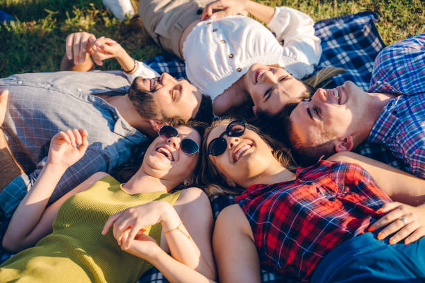 istock Happy friends lying in grass 1167013093