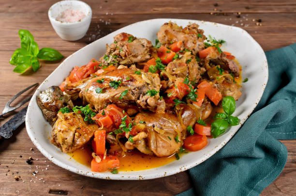 Roasted rabbit with vegetables and white wine sauce Rabbit stew with onions, carrots and tomatoes. Meat with vegetables stewed in white wine sauce rabbit game meat stock pictures, royalty-free photos & images