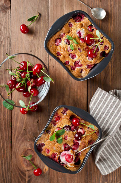 istock Cherry clafouti in portional ceramic forms on rustic wooden background. 1167013702