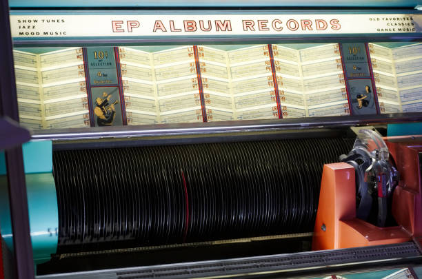Close-up of LP vinyl record with sound graphic equalizer and musical notes, against black background.