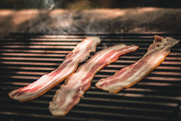 istock Three slices of bacon on the grill 1167015514