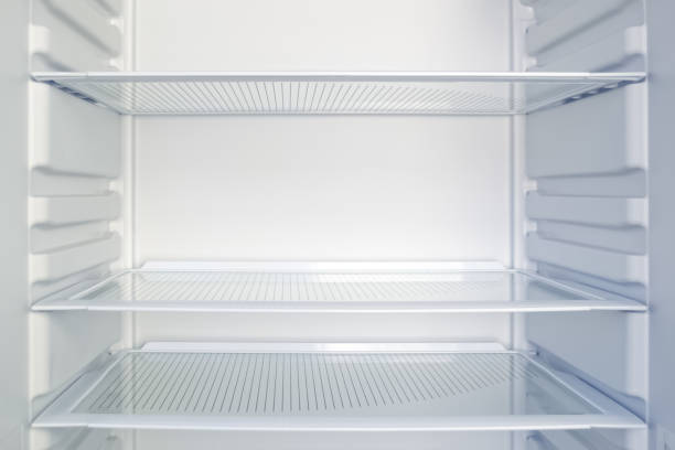 istock Empty open modern fridge with clean glass shelves. Diet and hunger concept 1167015648