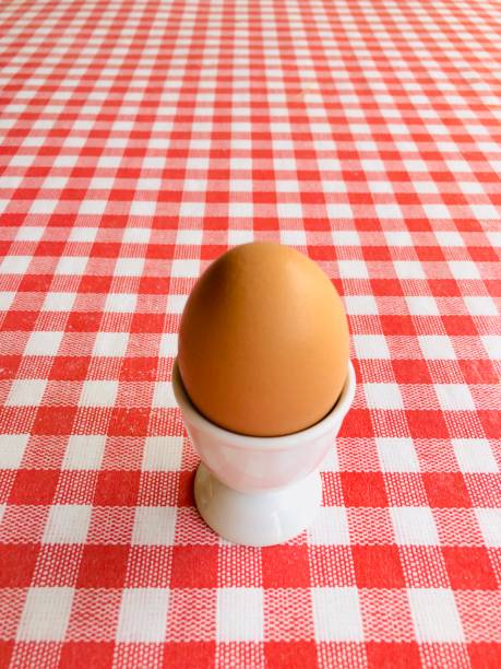Boiled egg on white egg cup