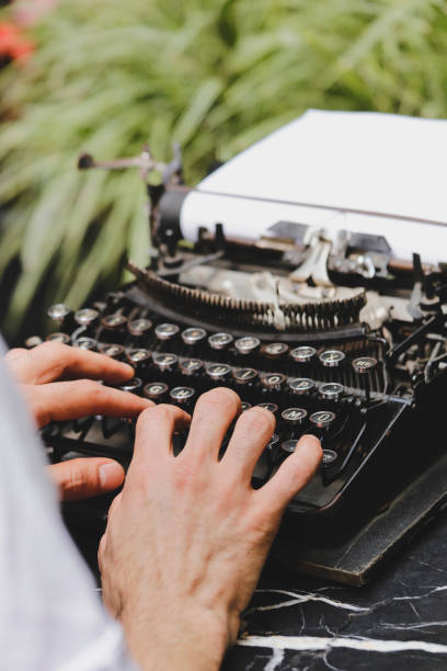 istock Hand of a young men writer writing on antique typewriter 1167019082