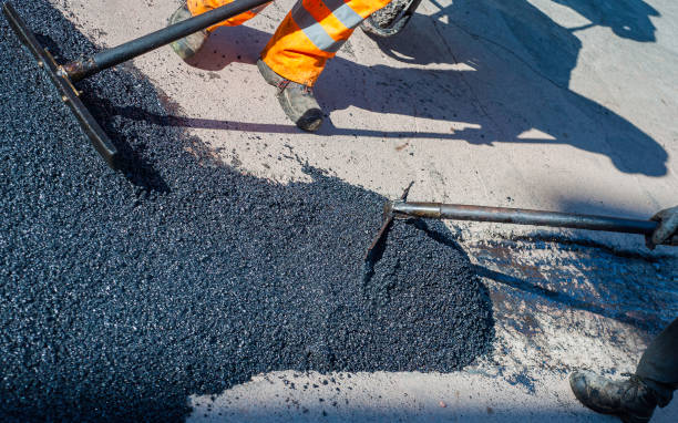 istock Construction workers during asphalting road works wearing coveralls. Manual labor on construction site. 1167020595