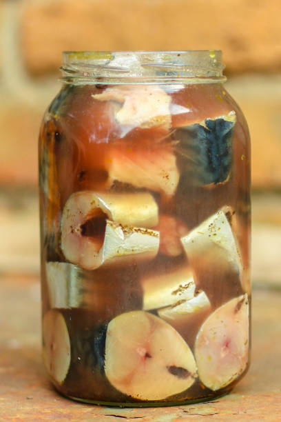 istock mackerel, fresh salted fish in a jar (pieces in brine). top view. food background 1167021775