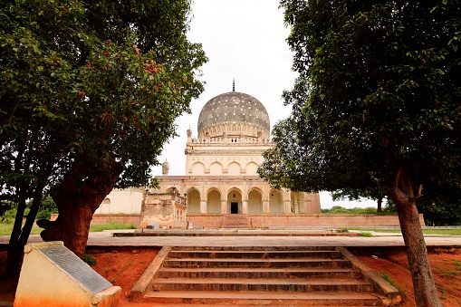 The Qutb Shahi Tombs are located in the Ibrahim Bagh, close to the famous Golconda Fort in Hyderabad, India. They contain the tombs and mosques built by the various kings of the Qutb Shahi dynasty. The galleries of the smaller tombs are of a single storey while the larger ones are two storied. In the centre of each tomb is a sarcophagus which overlies the actual burial vault in a crypt below. The domes were originally overlaid with blue and green tiles, of which only a few pieces now remain. The tombs were restored by the Telangana State Archaeology and Museums Department in collaboration with the Aga Khan Trust for Culture. The restoration work started in 2013 and is still in process.
