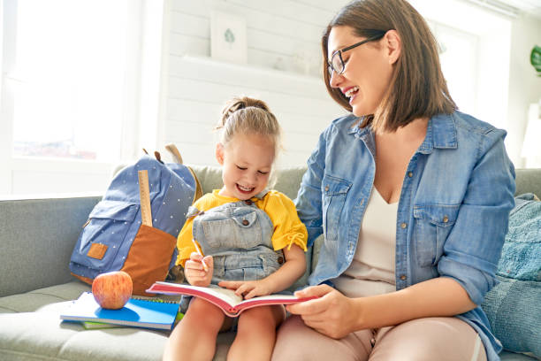 istock mother and her daughter are writing in notebook. 1167023530