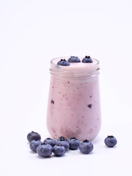 istock White yogurt and blueberry in a glass on a white background. 1167025784