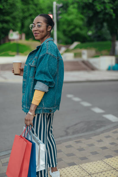 istock Young afro-american woman is walking with coffee 1167026168