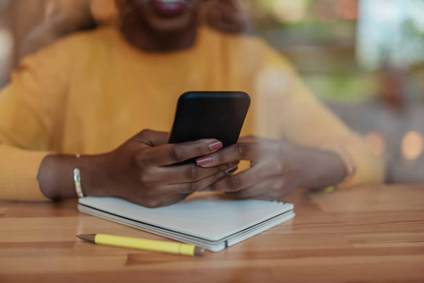 istock Young african american woman using modern smartphone 1167026380
