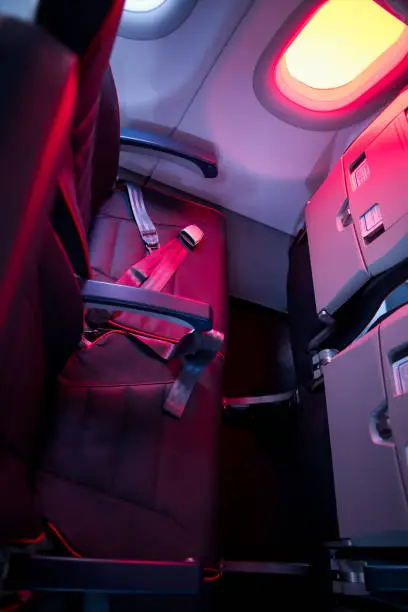 Photo of Airplane cabin seats with passengers. Economy class of new cheapest low-cost airlines without delay or cancellation of flight.