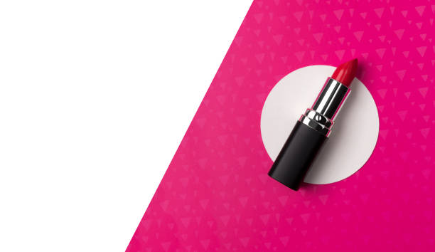 istock Bright red lipstick on creative neon pink background with copy space. 1167033113