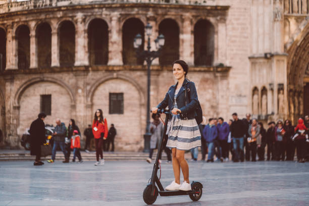 istock Woman riding scooter on her way to work 1167035717