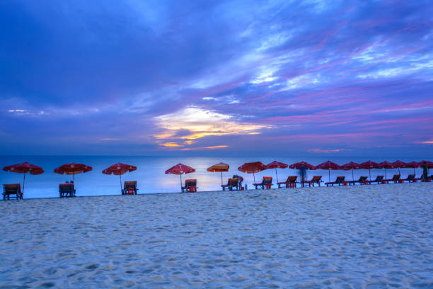Red  umbrella and chair waiting for the tourist travelling to Cox’s Bazar, Bangladesh after the sunset