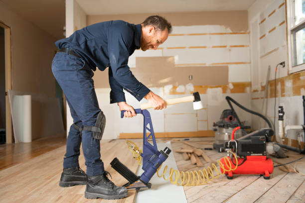 un trabajador masculino instala piso de madera en una casa - wood laminate flooring floor nail hammer fotografías e imágenes de stock