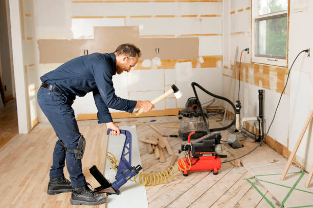 istock A Male Worker install wood floor on a house 1167036659