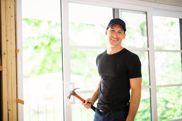 istock A handsome young man installing Double Sliding Patio Door in a new house construction site 1167036857