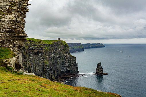 Irish countryside landscape of the Branaunmore sea stack in the Cliffs of Moher, geosites and geopark, Wild Atlantic Way, wonderful spring cloudy day in county Clare in Ireland