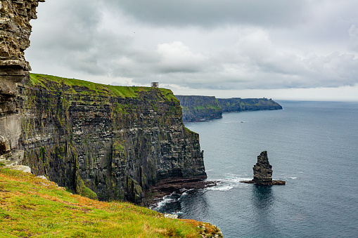 Stunning Irish landscape of the Cliffs of Moher and the Branaunmore sea stack, geosites and geopark, Wild Atlantic Way, wonderful cloudy spring day in County Clare in Ireland