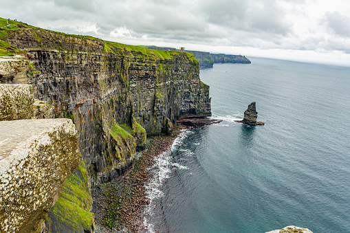 Beautiful landscape of the coast of the Cliffs of Moher and the Branaunmore sea stack, geosites and geopark, Wild Atlantic Way, wonderful cloudy spring day in county Clare in Ireland