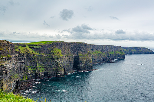 Stunning the Cliffs of Moher, geosites and geopark, Wild Atlantic Way, wonderful cloudy spring day in the countryside in County Clare in Ireland