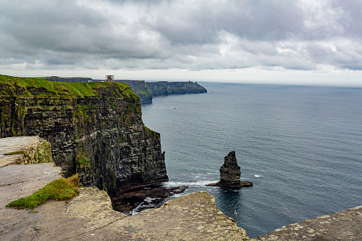 Spectacular landscape of the Cliffs of Moher and the Branaunmore sea stack, geosites and geopark, Wild Atlantic Way, wonderful cloudy spring day in county Clare in Ireland