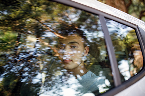 Smiling teenage boy in the car