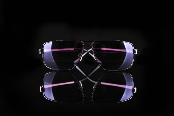Elegant sunglasses on black background