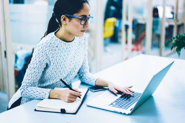 istock Professional female administrative manager of clinic organizing working schedule using application on laptop computer, woman secretary checking email box and sending feedbacks via netbook at office 1167039676