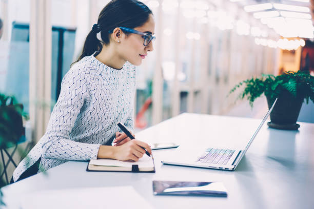 istock Pensive businesswoman reading information browsed on laptop computer making notes planning startup,female manager organizing working process in office creating scedulevia application on netbook 1167039678