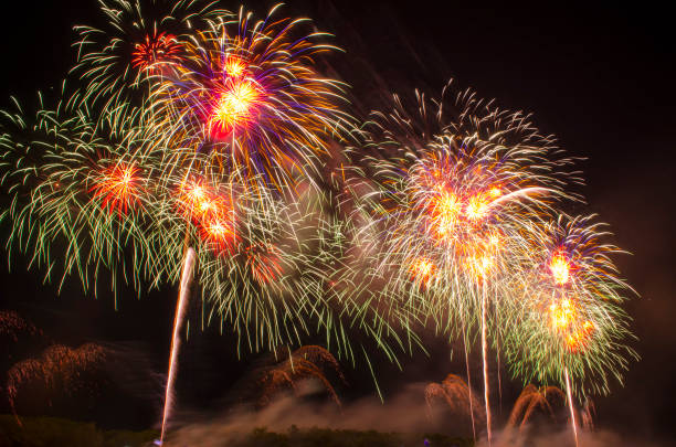istock Colorful fireworks. Fireworks are a class of explosive pyrotechnic devices used for entertainment purposes. Visible noise due to low light, soft focus, shallow DOF, slight motion blur 1167039759