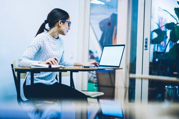 istock Young concentrated female manager browsing web page on netbook with blank screen searching information for job,clever student doing homework task on laptop computer autodidactic via online courses 1167039956