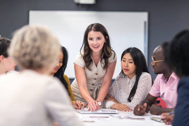 istock Female analyst presenting to business board members 1167040891