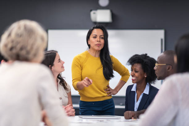 istock Female analyst presenting to business board members 1167040899
