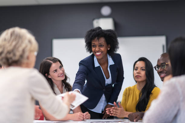 istock Female analyst presenting to business board members 1167040907