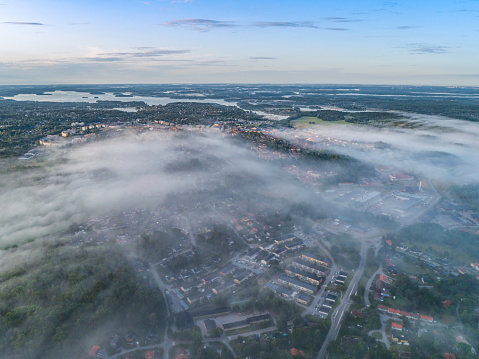 Aerial view over foggy rural landscape in Sweden