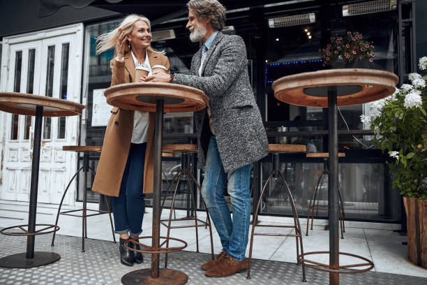 istock Smiling couple at the cafe table outdoors stock photo 1167042721