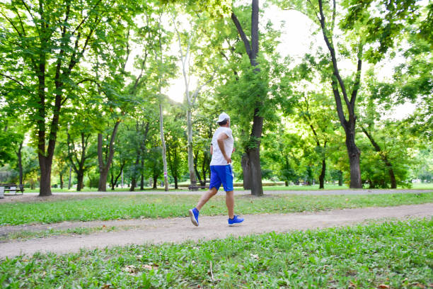 istock Middle-aged gray-haired man is recreating in the park 1167045068