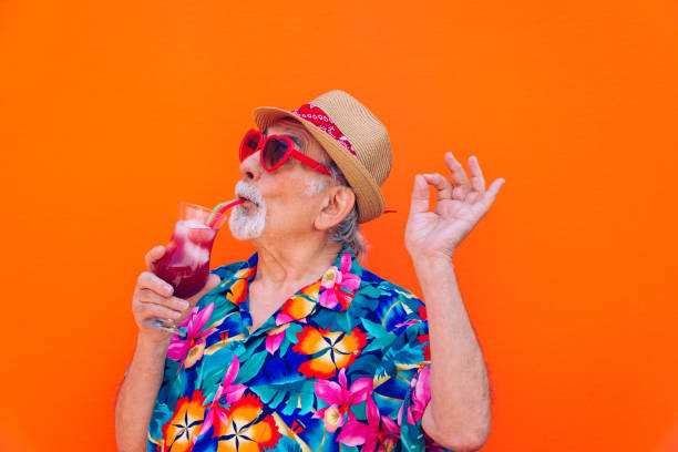 Eccentric senior man portrait Funny and extravagant senior man posing on colored background - Youthful old man in the sixties having fun and partying fun vacations stock pictures, royalty-free photos & images