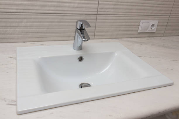 istock Ceramic white washbasin with stainless faucet 1167046244
