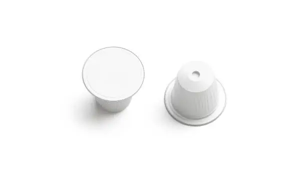 Photo of Blank white plastic coffee capsule mockup, isolated, top view