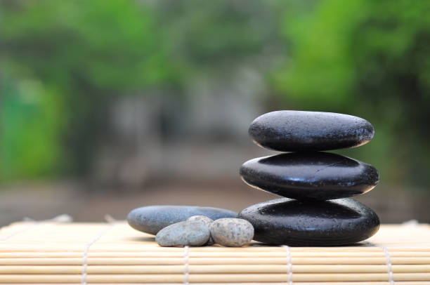 istock Pebble stones on nature bokeh background - SPA Concept 1167048515