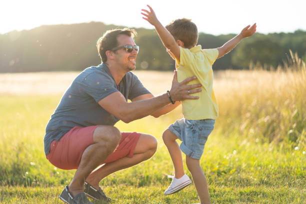 istock supportive males, happy father playing with four years old son outdoors in summer 1167048928