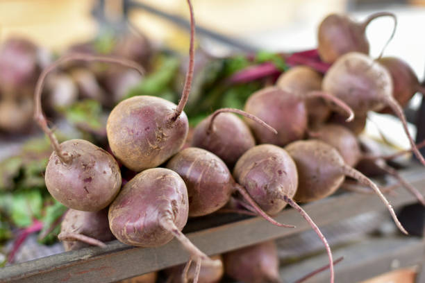 bundles of carrots and beets at the farmer's market
