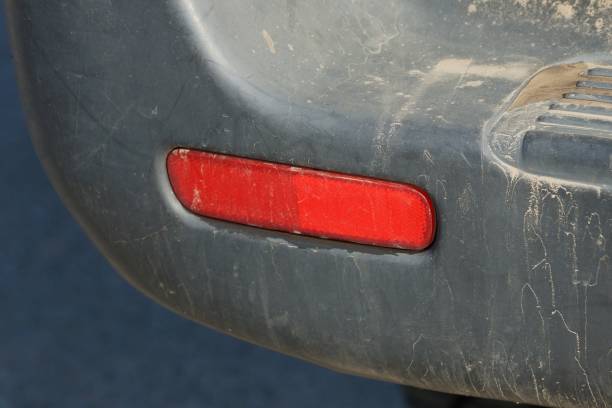 istock red plastic reflector on a black dirty car bumper 1167050777