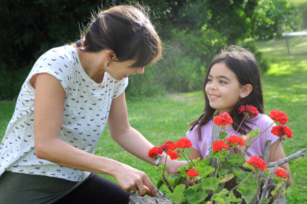 istock mother and daughter doing gardening 1167053971